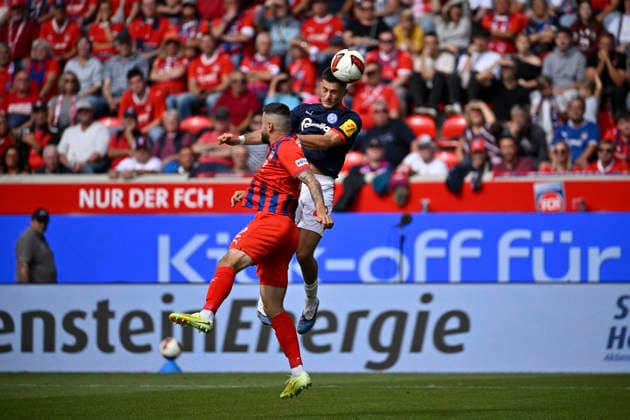 Heading duel, tackle, action: Adrian Kapralik (Holstein Kiel 20) vs. Marnon Busch (1 FC Heidenheim 1846 FCH 02); 1 FC Heidenheim 1846 FCH vs. Holstein Kiel KSV; September 13, 2026; DFL REGULATIONS PROHIBIT ANY USE OF PHOTOGRAPHS AS IMAGE SEQUENCES AND OR QUASI-VIDEO 1 FC Heidenheim 1846 FCH vs. Holstein Kiel KSV