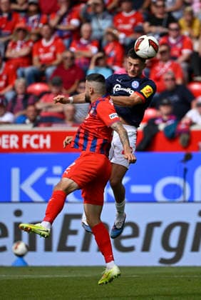 Heading duel, tackle, action: Adrian Kapralik (Holstein Kiel 20) vs. Marnon Busch (1 FC Heidenheim 1846 FCH 02); 1 FC Heidenheim 1846 FCH vs. Holstein Kiel KSV; September 13, 2026; DFL REGULATIONS PROHIBIT ANY USE OF PHOTOGRAPHS AS IMAGE SEQUENCES AND OR QUASI-VIDEO 1 FC Heidenheim 1846 FCH vs. Holstein Kiel KSV