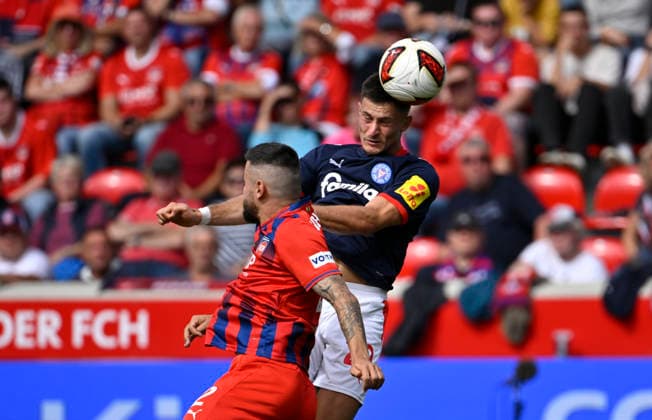 Heading duel, tackle, action: Adrian Kapralik (Holstein Kiel 20) vs. Marnon Busch (1 FC Heidenheim 1846 FCH 02); 1 FC Heidenheim 1846 FCH vs. Holstein Kiel KSV; September 13, 2026; DFL REGULATIONS PROHIBIT ANY USE OF PHOTOGRAPHS AS IMAGE SEQUENCES AND OR QUASI-VIDEO 1 FC Heidenheim 1846 FCH vs. Holstein Kiel KSV