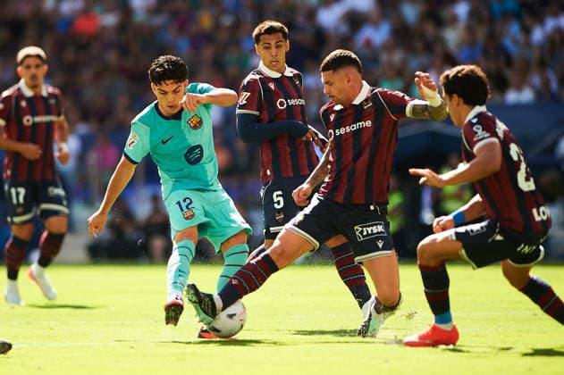 Xavi Espart of FC Barcelona and Adrian de la Fuente of Levante UD during the LaLiga EA Sports match between Levante UD and FC Barcelona at Estadi Ciutat de Valencia on September 13, 2026, in Valencia, Spain