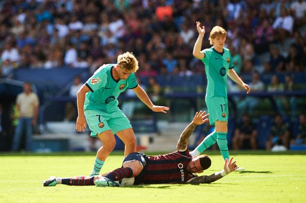 Fermin Lopez of FC Barcelona and Adrian de la Fuente of Levante UD during the LaLiga EA Sports match between Levante UD and FC Barcelona at Estadi Ciutat de Valencia on September 13, 2026, in Valencia, Spain