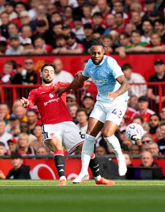 Manchester, England, 13th September 2026. Bruno Fernandes of Manchester United, ManU with Antoine Semenyo of Manchester City during the Manchester United vs Manchester City Premier League match at Old Trafford, Manchester. Picture credit should read: Andrew Yates Sportimage EDITORIAL USE ONLY. No use with unauthorised audio, video, data, fixture lists, club league logos or live services. Online in-match use limited to 120 images, no video emulation. No use in betting, games or single club league player publications. SPI_019_AY_MAN_UTD_MAN_CITY SPI-4993-0020