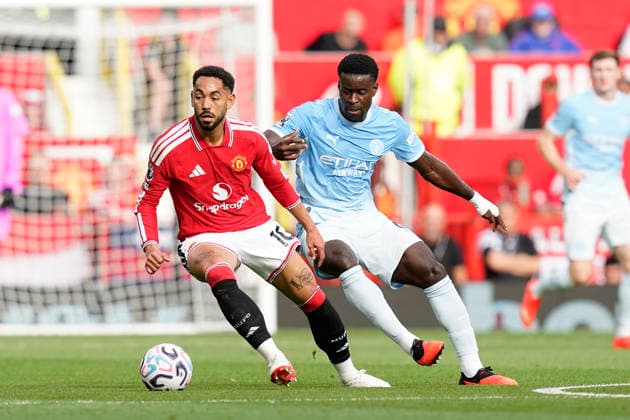 Manchester, England, 13th September 2026. Matheus Cunha of Manchester United, ManU with Marc Guà hi of Manchester City during the Manchester United vs Manchester City Premier League match at Old Trafford, Manchester. Picture credit should read: Andrew Yates Sportimage EDITORIAL USE ONLY. No use with unauthorised audio, video, data, fixture lists, club league logos or live services. Online in-match use limited to 120 images, no video emulation. No use in betting, games or single club league player publications. SPI_023_AY_MAN_UTD_MAN_CITY SPI-4993-0024