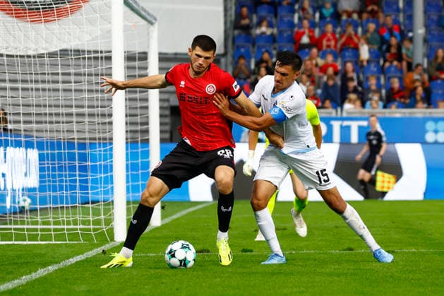 13.09.2026, xavx, Fussball 3.Liga, SV Wehen Wiesbaden - SV Waldhof Mannheim v.l. Moritz Flotho (SV Wehen Wiesbaden), Claudio Kammerknecht (SV Waldhof Mannheim) Wiesbaden