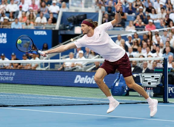 Alexander Zverev of Germany stretches to hit a return to Ben Shelton in the first set of the Men s Finals match in Arthur Ashe Stadium at the 2026 US Open Tennis Championship at the USTA Billie Jean King National Tennis Center in New York City on Sunday, September 13, 2026.  NYP20260913802 COREYxSIPKIN