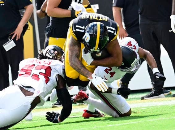 Pittsburgh Steelers wide receiver Michael Pittman Jr. (11) dives between Atlanta Falcons linebacker Kendal Daniels (53) and Atlanta Falcons cornerback A.J. Terrell Jr. (24) for a gain of 21 yards in the first quarter against the Atlanta Falcons at Acrisure Stadium on Sunday, Sept. 13, 2026 in Pittsburgh.  PIT2026091304 ARCHIExCARPENTER