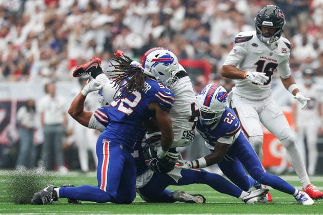 HOUSTON, TX - SEPTEMBER 13: Running back Woody Marks 4 of the Houston Texans is flipped upside down by safety Cole Bishop 24 of the Buffalo Bills, linebacker Kaleb Elarms-Orr 52 of the Buffalo Bills and cornerback Dee Alford 23 of the Buffalo Bills during the NFL, American Football Herren, USA game between the Houston Texans and the Buffalo Bills on September 13, 2026, at Reliant Stadium in Houston, TX.(Photo by David Buono Icon Sportswire) NFL: SEP 13 Bills at Texans EDITORIAL USE ONLY Icon260913015