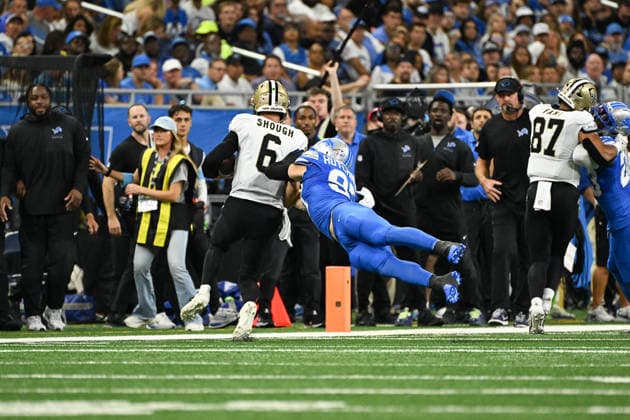 DETROIT, MI - SEPTEMBER 13: New Orleans Saints quarterback Tyler Shough (6) is pushed out of bounds by Detroit Lions defensive end Aidan Hutchinson (97) during the Detroit Lions versus New Orleans Saints game on Sunday September 13, 2026 at Ford Field in Detroit, MI. (Photo by Steven King Icon Sportswire) NFL, American Football Herren, USA SEP 13 Saints at Lions EDITORIAL USE ONLY Icon2582026091300429