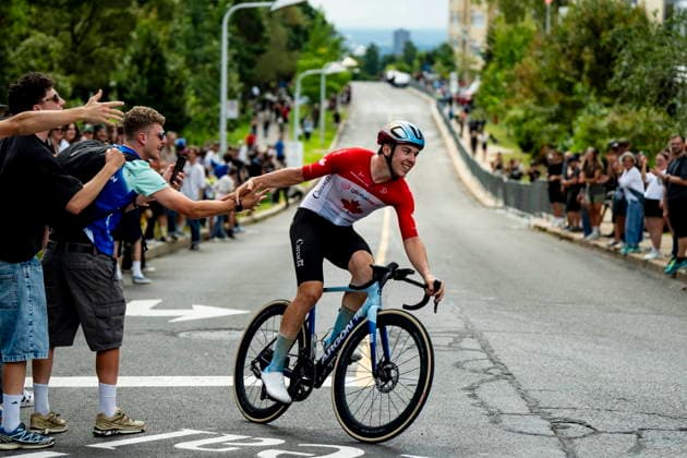 September 13, 2026, Montreal, Pq, CANADA: Adam Smith riding for Team Canada greets a fan while racing during the Grand Prix Cycliste de Montreal on Sunday, Sept. 13, 2026. Canada News - September 13, 2026  - ZUMAc35_ 20260913_zaf_c35_056 Copyright: xChristopherxKatsarovx