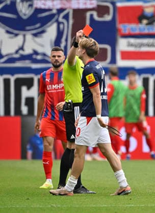 Referee Justin Hasmann shows a yellow-red card and sends off Jonas Therkelsen of Holstein Kiel 10 for a foul on Mikkel Kaufmann of 1. FC Heidenheim 1846 (FCH 29) — not shown in the frame. 1. FC Heidenheim 1846 (FCH) vs. Holstein Kiel KSFri, Sep 13, 2026 DFL regulations prohibit any use of photographs as image sequences and or quasi-video. 1 FC Heidenheim 1846 FCH vs. Holstein Kiel KSV