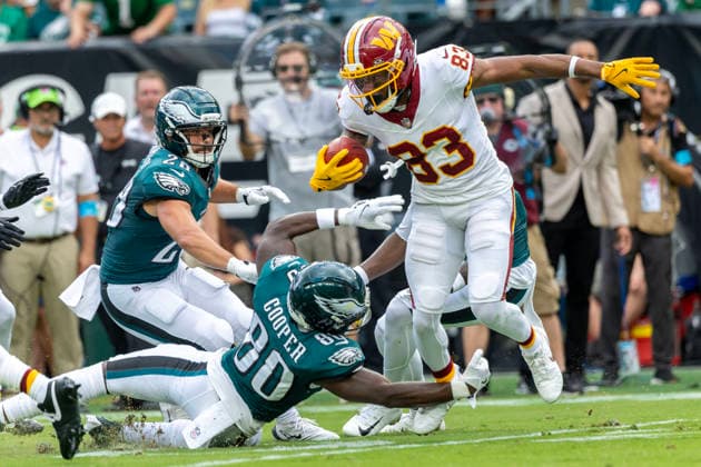 Washington Commanders wide receiver Jaylin Lane (83) is brought down at the twenty-two yard line by Philadelphia Eagles wide receiver Darius Cooper (80) for a first down in the first quarter of NFL, American Football Herren, USA action at Lincoln Financial Field in Philadelphia, Pennsylvania on Sunday, September 13, 2026.  PHI20260913006 LAURENCExKESTERSON