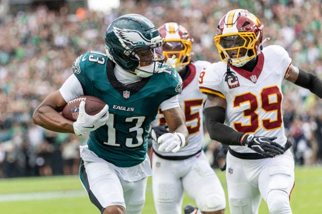 Philadelphia Eagles wide receiver Dontayvion Wicks (13) carries the ball past Washington Commanders safety Jeremy Reaves (39) for a first down at the six yard line in the first quarter of NFL, American Football Herren, USA action at Lincoln Financial Field in Philadelphia, Pennsylvania on Sunday, September 13, 2026.  PHI20260913007 LAURENCExKESTERSON