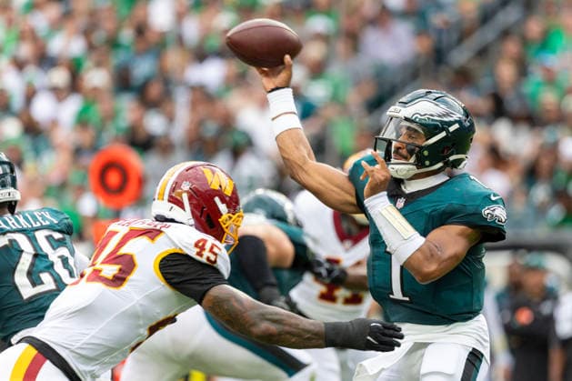 Philadelphia Eagles quarterback Jalen Hurts (1) is rushed by Washington Commanders linebacker K lavon Chaisson (45) in the second quarter of NFL, American Football Herren, USA action at Lincoln Financial Field in Philadelphia, Pennsylvania on Sunday, September 13, 2026.  PHI20260913011 LAURENCExKESTERSON