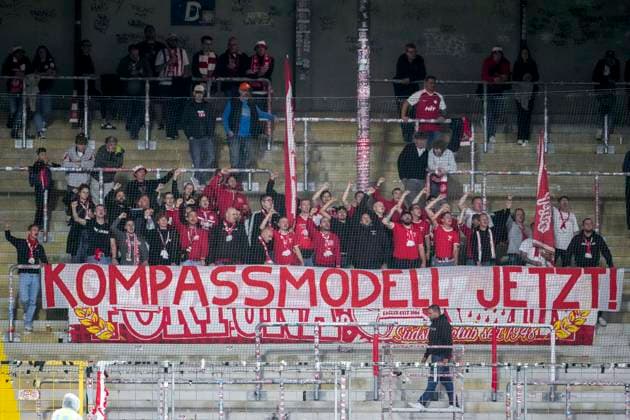SC Fortuna Köln fans display a banner in the fan section with the slogan Compass Model Now ; fans, ultras, audience, spectators, mood, atmosphere, stadium, protest, protest action calling for reform of the Regionalliga; protesting, action, Regionalliga reform, September 13, 2026, Sinsheim, Germany, soccer, 3rd Division, TSG 1899 Hoffenheim II vs. SC Fortuna Köln, DFB and DFL regulations prohibit any use of photographs as image sequences and or quasi-video xozx
