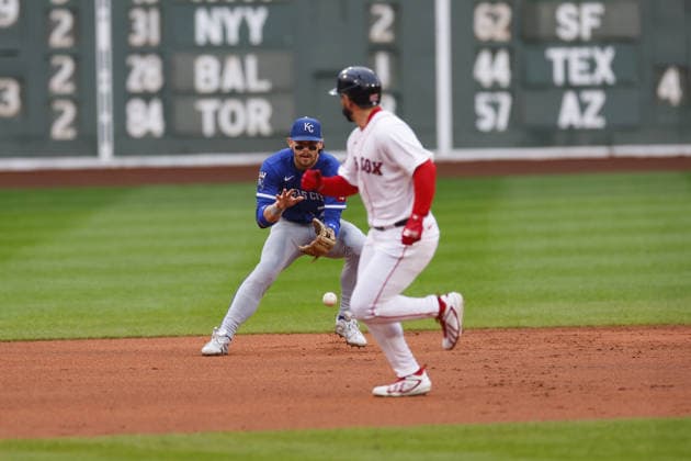 Kansas City Royals shortstop Bobby Witt Jr., left, fields the ball as Boston Red Sox base runner Wilyer Abreu looks back during the first inning at Fenway Park in Boston, Massachusetts on Sunday, September 13, 2026.  BOP20260913008 CJxGUNTHER