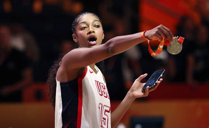 Angel Reese poses with her gold medal, celebrating the World Championship; Team USA World Champions; Joy; Emotion; Sports; Basketball; FIBA World Cup; World Championship; Women s World Championship; World Championship Final; 2026–2027 Season; September 13, 2026; France vs. USA