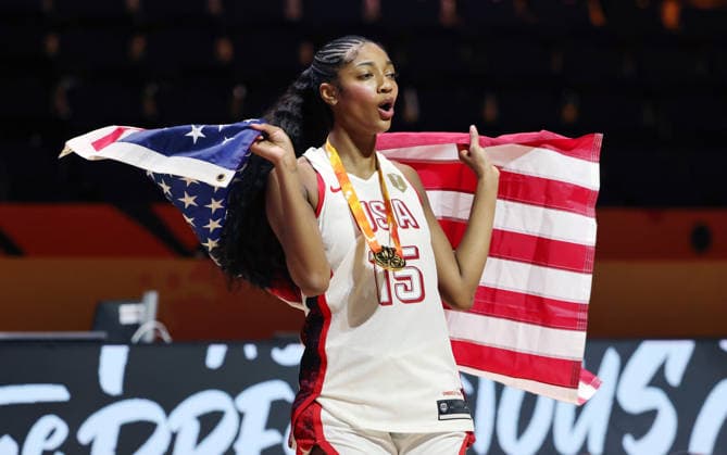 Aliyah Boston poses with her gold medal and the U.S. flag, celebrating Team USA s World Championship victory. Joy, Emotion, Sports, Basketball, FIBA World Cup, World Championship, Women s World Championship, World Championship Final, 2026-2027 Season, September 13, 2026, France vs. USA