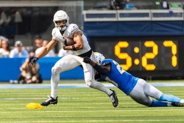 September 13, 2026, Inglewood, California, USA: Arizona Cardinals wide receiver Michael Wilson (14) is tackled by Los Angeles Chargers cornerback Cam Hart (20) during an NFL, American Football Herren, USA football game, in Inglewood, Calif. on Sunday 13, 2026. NHL, Eishockey Herren, USA 2026: Arizona Cardinals 26:14 LA Chargers  - ZUMAc68_ 20260913_zaf_c68_032 Copyright: xRingoxChiux