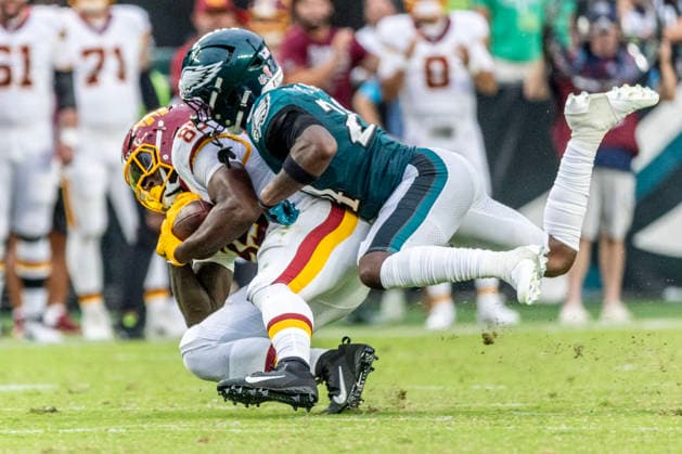 Washington Commanders tight end Chig Okonkwo (85) is brought down by Philadelphia Eagles safety Andrew Mukuba (24) at the forty-three yard line for a first down in the third quarter of NFL, American Football Herren, USA action at Lincoln Financial Field in Philadelphia, Pennsylvania on Sunday, September 13, 2026.  PHI20260913016 LAURENCExKESTERSON