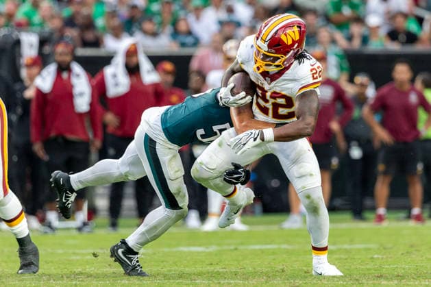 Washington Commanders running back Jacory Croskey-Merritt (22) is tackled by Philadelphia Eagles linebacker Zack Baun (53) at the thirty-five yard line for a second down in the third quarter of NFL, American Football Herren, USA action at Lincoln Financial Field in Philadelphia, Pennsylvania on Sunday, September 13, 2026.  PHI20260913017 LAURENCExKESTERSON