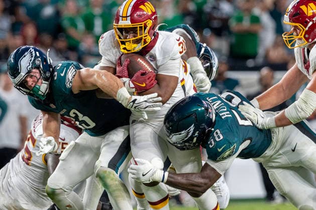 Washington Commanders running back Kaytron Allen (31) is tackled by Philadelphia Eagles linebacker Jalyx Hunt (58) at the fourteen yard line for a second down in the fourth quarter of NFL, American Football Herren, USA action at Lincoln Financial Field in Philadelphia, Pennsylvania on Sunday, September 13, 2026.  PHI20260913021 LAURENCExKESTERSON