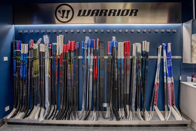 Racks holding all the players hockey sticks, with pucks bearing each player s number above them: GER, EHC Red Bull Munich, ice hockey, DEL, Open Locker Room, September 14, 2026. Photo by HMB Media, Heike Feiner Copyright: HMBxMedia HeikexFeiner