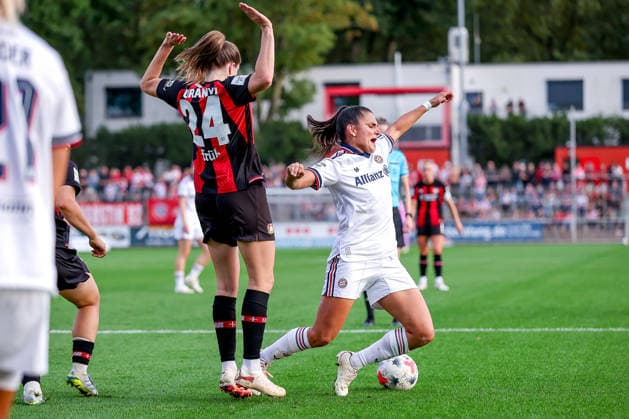 September 14, 2026, Soccer, Women s Bundesliga 1, Bayer 04 Leverkusen vs. FC Bayern Munich, Matchday 4, Ulrich Haberland Stadium, 2026–27 season: Lilla Turanyi of Bayer 04 Leverkusen (24) in a tackle against Jovana Damnjanovic of FC Bayern Munich (09). DFB regulations prohibit any use of photographs as image sequences and or quasi-video. North Rhine-Westphalia, Germany