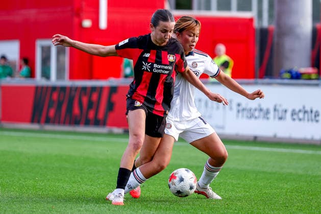 September 14, 2026, Soccer, Women s Bundesliga 1, Bayer 04 Leverkusen vs. FC Bayern Munich, Matchday 4, Ulrich Haberland Stadium, 2026–27 season. Loreen Bender (Bayer 04 Leverkusen, No. 19) in a tackle against Momoko Tanikawa (FC Bayern Munich, No. 18). DFB regulations prohibit any use of photographs as image sequences and or quasi-video. North Rhine-Westphalia, Germany