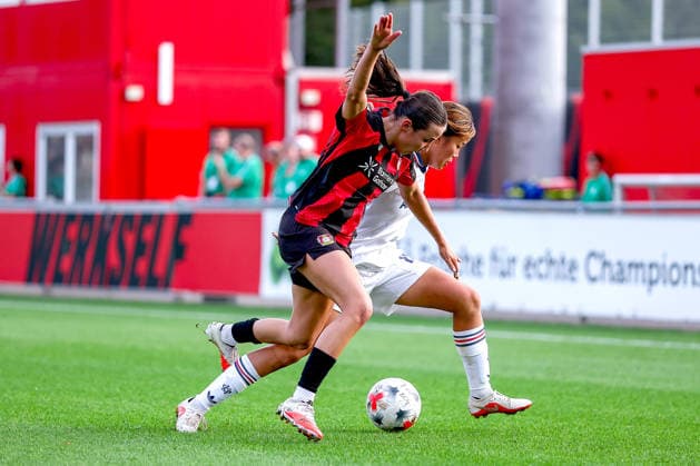 September 14, 2026, Soccer, Women s Bundesliga 1, Bayer 04 Leverkusen vs. FC Bayern Munich, Matchday 4, Ulrich Haberland Stadium, 2026–27 season. Loreen Bender (Bayer 04 Leverkusen, No. 19) in a tackle against Momoko Tanikawa (FC Bayern Munich, No. 18). DFB regulations prohibit any use of photographs as image sequences and or quasi-video. North Rhine-Westphalia, Germany