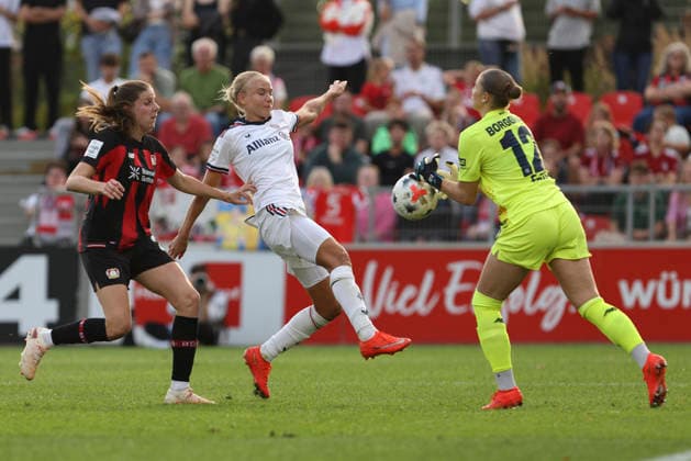 Lilla Turanyi of Bayer 04 Leverkusen, Pernille Harder of FC Bayern Munich, and goalkeeper Rafaela Borggraefe of Bayer 04 Leverkusen in a duel during the Women s Bundesliga match between Bayer 04 Leverkusen and FC Bayern Munich, at Ulrich Haberland Stadium on September 14, 2026, in Leverkusen, Germany. Photo by Oliver Kaelke, DeFodi Images. Lilla Turanyi of Bayer 04 Leverkusen, Pernille Harder of FC Bayern Munich, and goalkeeper Rafaela Borggraefe of Bayer 04 Leverkusen battle for the ball during the Bundesliga match between Bayer 04 Leverkusen and FC Bayern Munich at Ulrich Haberland Stadium on September 14, 2026 in Leverkusen, Germany. Photo by Oliver Kaelke, DeFodi Images. DFB and DFL regulations prohibit any use of photographs as image sequences and or quasi-video. Photo by Oliver Kaelke, DeFodi Images.