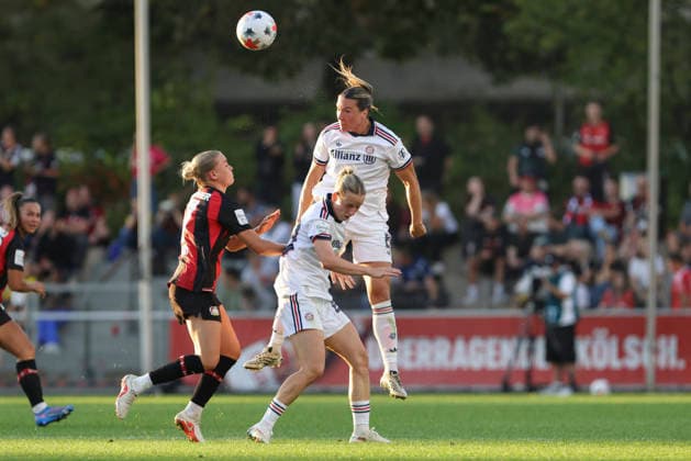 Cornelia Kramer of Bayer 04 Leverkusen, Vanessa Gilles of FC Bayern Munich, and Franziska Kett of FC Bayern Munich in a tackle during the Women s Bundesliga match between Bayer 04 Leverkusen and FC Bayern Munich, Ulrich Haberland Stadium on September 14, 2026, in Leverkusen, Germany. Photo by Oliver Kaelke, DeFodi Images. Cornelia Kramer of Bayer 04 Leverkusen, Vanessa Gilles of FC Bayern Munich and Franziska Kett of FC Bayern Munich battle for the ball during the Bundesliga match between Bayer 04 Leverkusen and FC Bayern Munich at Ulrich Haberland Stadium on September 14, 2026 in Leverkusen, Germany. Photo by Oliver Kaelke, DeFodi Images. DFB and DFL regulations prohibit any use of photographs as image sequences and or quasi-video. Photo by Oliver Kaelke, DeFodi Images.