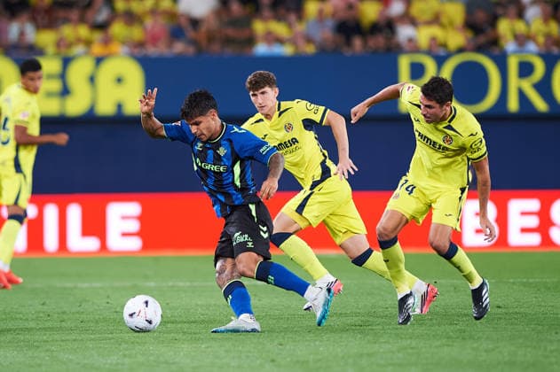 Pau Navarro of Villarreal CF and Cucho Hernandez of Real Betis during the LaLiga EA Sports match between Villarreal CF and Real Betis Balompie at Estadio de la Cerámica on September 14, 2026, in Villarreal, Spain