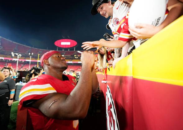 Kansas City Chiefs running back Kenneth Walker III (9) signs an autograph for a young fan after a big win against the Broncos on Monday Night Football at Arrowhead Stadium in Kansas City, Missouri on Monday September 14, 2026.  KCP2026091426 JONxROBICHAUD