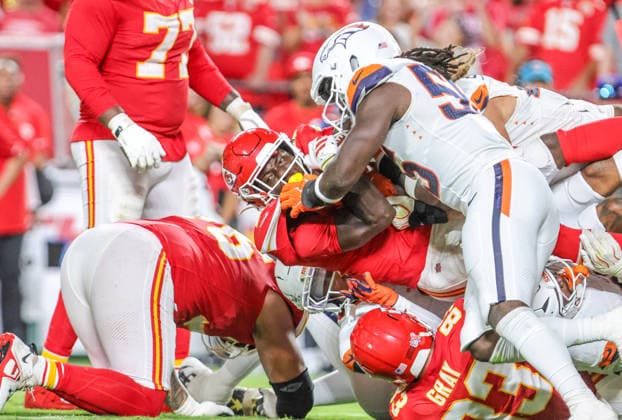 Sep 14, 2026: Kansas City Chiefs running back Emmett Johnson (10) gets tackled during a run against the Denver Broncos in Kansas City, MO, USA; at Arrowhead Stadium. Mandatory Credit: -Cal Media Kansas City USA - ZUMAc04_ 20260914_zma_c04_135 Copyright: xRomanxPunox