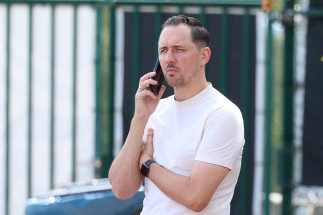 September 15, 2026, xrekx, Soccer, 2. Bundesliga, 1. FC Kaiserslautern Training: Marcel Klos, Sports Director of 1. FC Kaiserslautern, on his cell phone, smartphone, or phone in Kaiserslautern