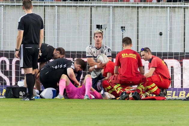 Goalkeeper Marius Liesegang of Jena (No. 1) is being treated while lying on the ground due to an injury; Hallescher FC vs. FC Carl Zeiss Jena; soccer; Northeast Regional League; Matchday 9; 2026–27 season; September 15, 2026; Halle Leuna Chemie Stadium; ST Deutschland