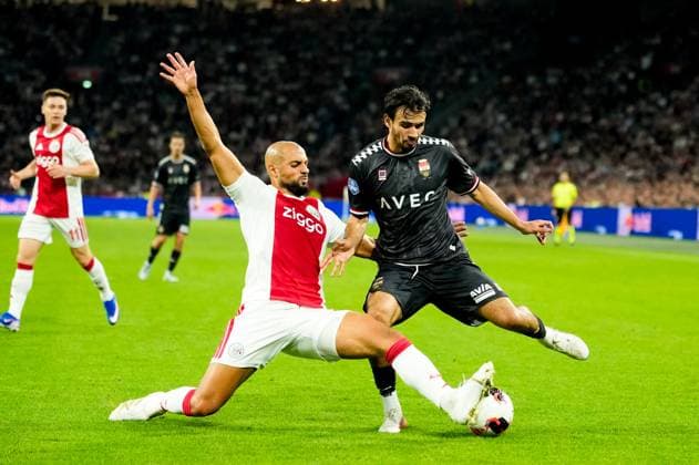AMSTERDAM , 15-09-2026, Johan Cruijff ArenA , season 2026 2027 , Dutch Eredivisie football , match between Ajax and Willem II , Picture shows Ajax player Sofyan Amrabat and Willem II player Nathan Tjoe-A-On Ajax - Willem II  x207104044x Copyright: