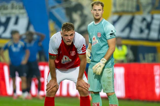 Regionalliga Northeast Season 26-27: Hallescher FC vs. FC Carl Zeiss Jena, Halle, Germany, September 15, 2026. Pictured, from left: Vin Kastull (Halle) and goalkeeper Luca Bendel (Halle), Halle Saale Leuna Chemie Stadium, Saxony-Anhalt, Germany