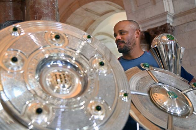Coach Vincent KOMPANY of Bayern Munich stands behind the trophies, cups, and awards won during the 2025–26 season,Championship Trophy, DFB Cup, Super Cup; Markus SÖDER, Minister-President of Bavaria and CSU Chairman, welcomes the championship teams of FC Bayern Munich in the Kuppelsaal at the State Chancellery in Munich on September 16, 2026