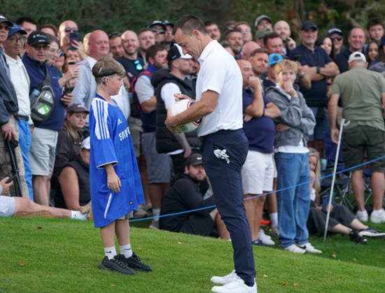 Golf - DP World Tour (European Tour) ˜Rolex Series™ - 2026 BMW PGA, Golf Herren Championship - Celebrity Pro-Am Round - West Course, Wentworth Club - Wednesday 16th September 2026 John Terry signs a Football for a young Chelsea supporter 