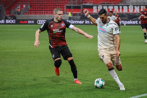 Tackle between Lars Lokotsch of FC Ingolstadt 04 (No. 13) and Klaus Gjasula of TSG Hoffenheim II (No. 5) during the match between FC Ingolstadt 04 and TSG Hoffenheim II on September 16, 2026, DFB regulations prohibit any use of photographs as image sequences and or quasi-video. GER, Soccer, 3. Liga, Matchday 6, FC Ingolstadt 04 vs. TSG Hoffenheim II, September 16, 2026, Audi Sportpark Ingolstadt Copyright: xEibner-Pressefoto OliverxSTRISCHx EP-OSH