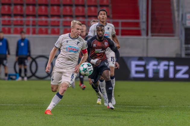 Ingolstadt, Germany, August 8, 2026, 3rd League 2026–2027, Matchday 6: FC Ingolstadt 04 vs. TSG Hoffenheim II. Pictured from left, in a tackle: Valentin Laessig (TSG II) and Keanan Bennetts (FCI). DFB and DFL regulations prohibit any use of photographs as image sequences and or quasi-video. Audi Sportpark Bayern Copyright: xFotostandx xSchäferx