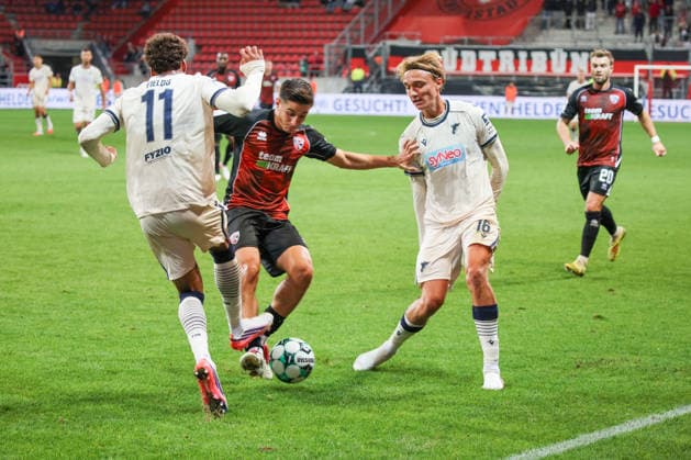 Emre Guel of FC Ingolstadt 04, No. 5, beats Luis Engeln of TSG Hoffenheim II, No. 16, and Jykese Fields of TSG Hoffenheim II, No. 11, during the FC Ingolstadt 04 vs. TSG Hoffenheim II match on September 16, 2026, DFB regulations prohibit any use of photographs as image sequences and or quasi-video. GER, Soccer, 3. Liga, Matchday 6, FC Ingolstadt 04 vs. TSG Hoffenheim II, September 16, 2026, Audi Sportpark Ingolstadt Copyright: xEibner-Pressefoto OliverxSTRISCHx EP-OSH