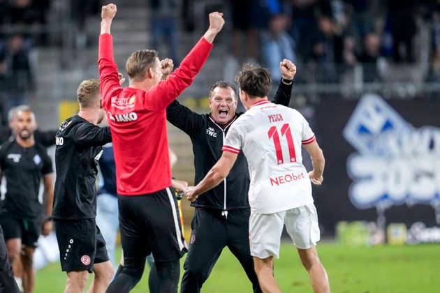 From left: Uwe Koschinat, coach, head coach, Essen, and Noah Pesch, Essen, 11, player for Rot Weiss Essen, Celebration after the final whistle, joy over the victory, winners, celebrating, cheerful, positive, happy, optimistic, highlight, action, September 16, 2026, Mannheim, Germany, soccer, 3rd Division, SV Waldhof Mannheim vs. Rot-Weiss Essen, DFB and DFL regulations prohibit any use of photographs as image sequences and or quasi-video xozx
