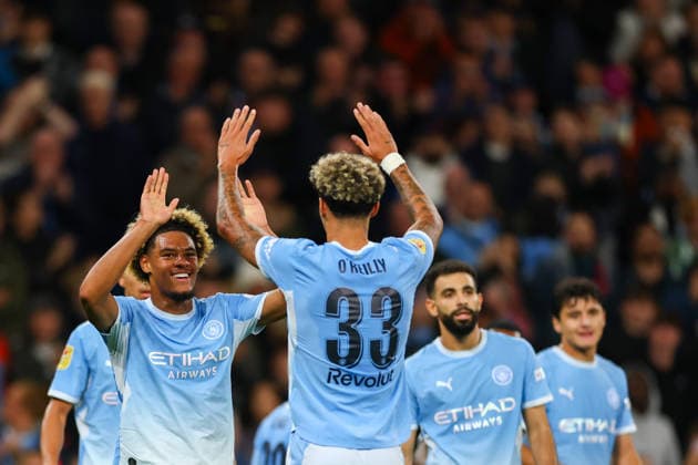 17th September 2026; Etihad Stadium, Manchester, England; Carabao Cup Football, Manchester City versus Norwich City; Floyd Samba of Manchester City is congratulated by team mates after scoring to make it 1-0 in the 29th minute RogerxEvans
