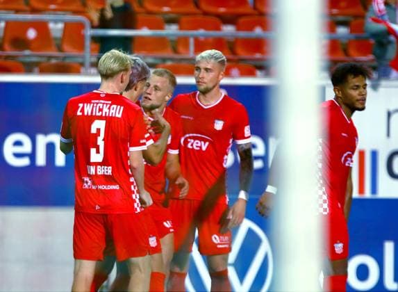 A crowd surrounds goal scorer Theo Gunnar Martens of Zwickau after the 1–0 soccer match in the 2026–27 Regionalliga Nordost between FSV Zwickau and Hallescher FC on September 18, 2026. FSV Zwickau vs. Hallescher FC