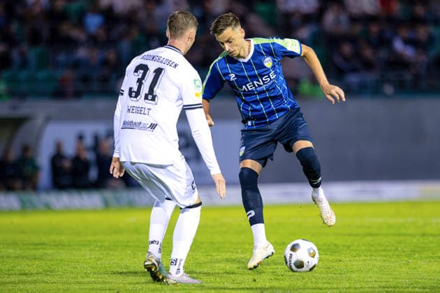 September 18, 2026, KWilkowski, Soccer, Regionalliga West, SV Rödinghausen vs. FC Gütersloh, Häcker Wiehenstadion, Matchday 9, 2026–2027 Season: Patrik Twardzik of FC Gütersloh (18) in a tackle against Henri Weigelt of SV Rödinghausen (31). DFB regulations prohibit any use of photographs as image sequences and or quasi-video. Photo: xKamilxWilkowskixPressefotoKochx, North Rhine-Westphalia Germany