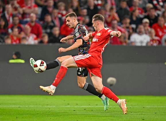September 18, 2026, 2026–2027 Bundesliga Season, Matchday 4, FC Bayern Munich vs. 1. FC Union Berlin, at the Allianz Arena in Munich, from left: Josip Stanisic (Bayern Munich) vs. Michael Aebischer (Union Berlin)