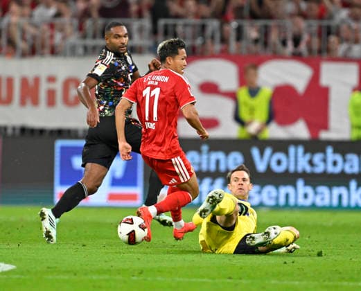 September 18, 2026, 2026–2027 Bundesliga, Matchday 4, FC Bayern Munich vs. 1. FC Union Berlin, at the Allianz Arena in Munich, Woo Yeong Jeong of Union Berlin is denied by goalkeeper Manuel Neuer of FC Bayern Munich