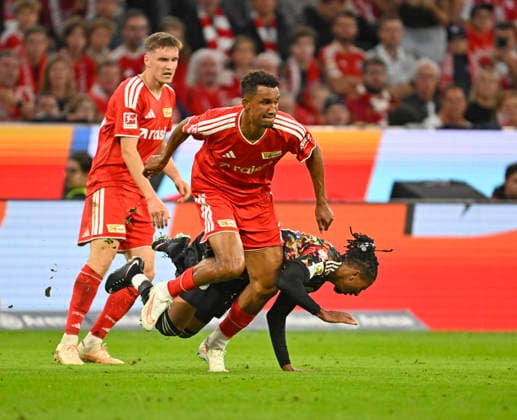 September 18, 2026, 2026–2027 Bundesliga Season, Matchday 4, FC Bayern Munich vs. 1. FC Union Berlin, at the Allianz Arena in Munich, Felix Uduokhai (Union Berlin) vs. Michael Olise (FC Bayern Munich)